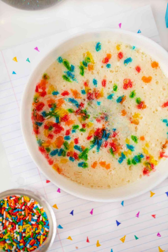Microwave Vanilla Cake in bowl with Rainbow Sprinkles