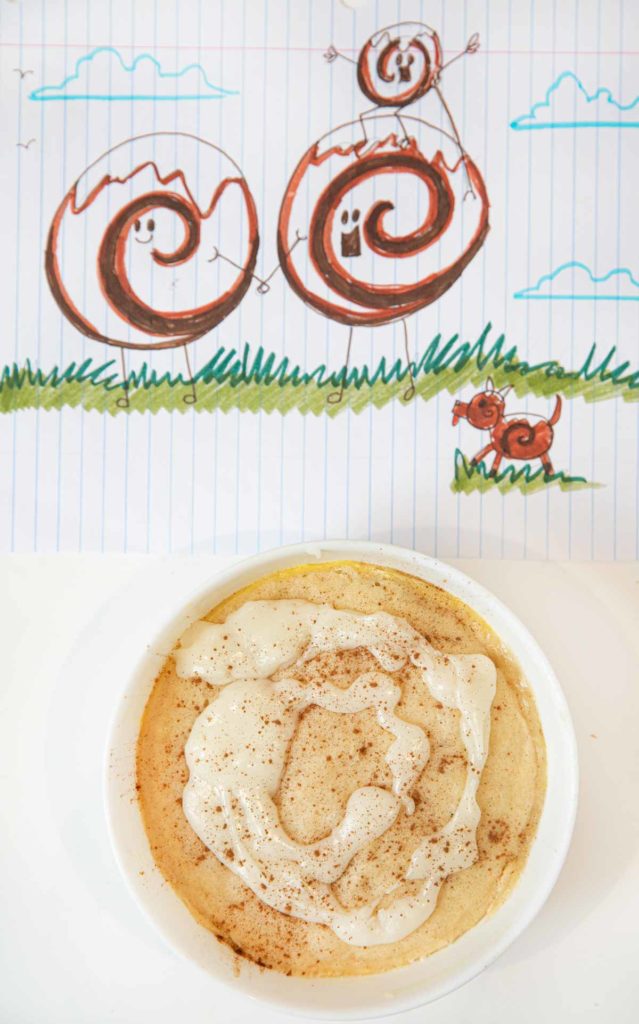Microwave Cinnamon Roll Cake in Cereal Bowl on notebook
