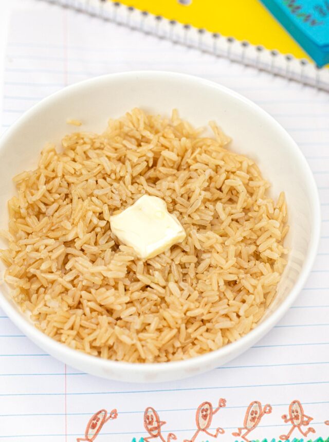 Microwave Brown Rice in bowl with pat of butter