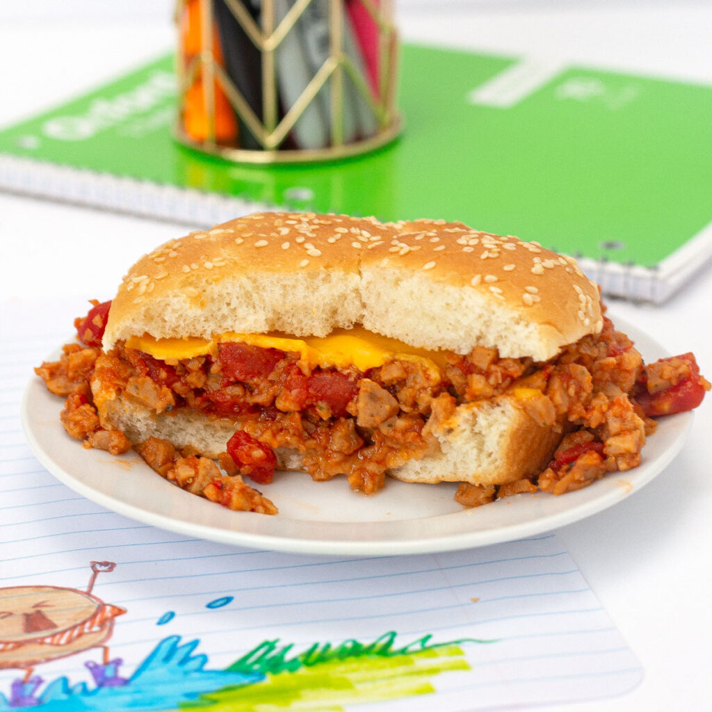 Microwave Sloppy Joes sandwich on plate with bite removed