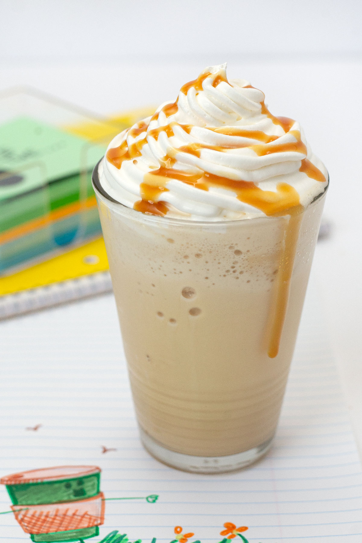 Caramel Frappuccino in cup topped with whipped cream and caramel drizzle