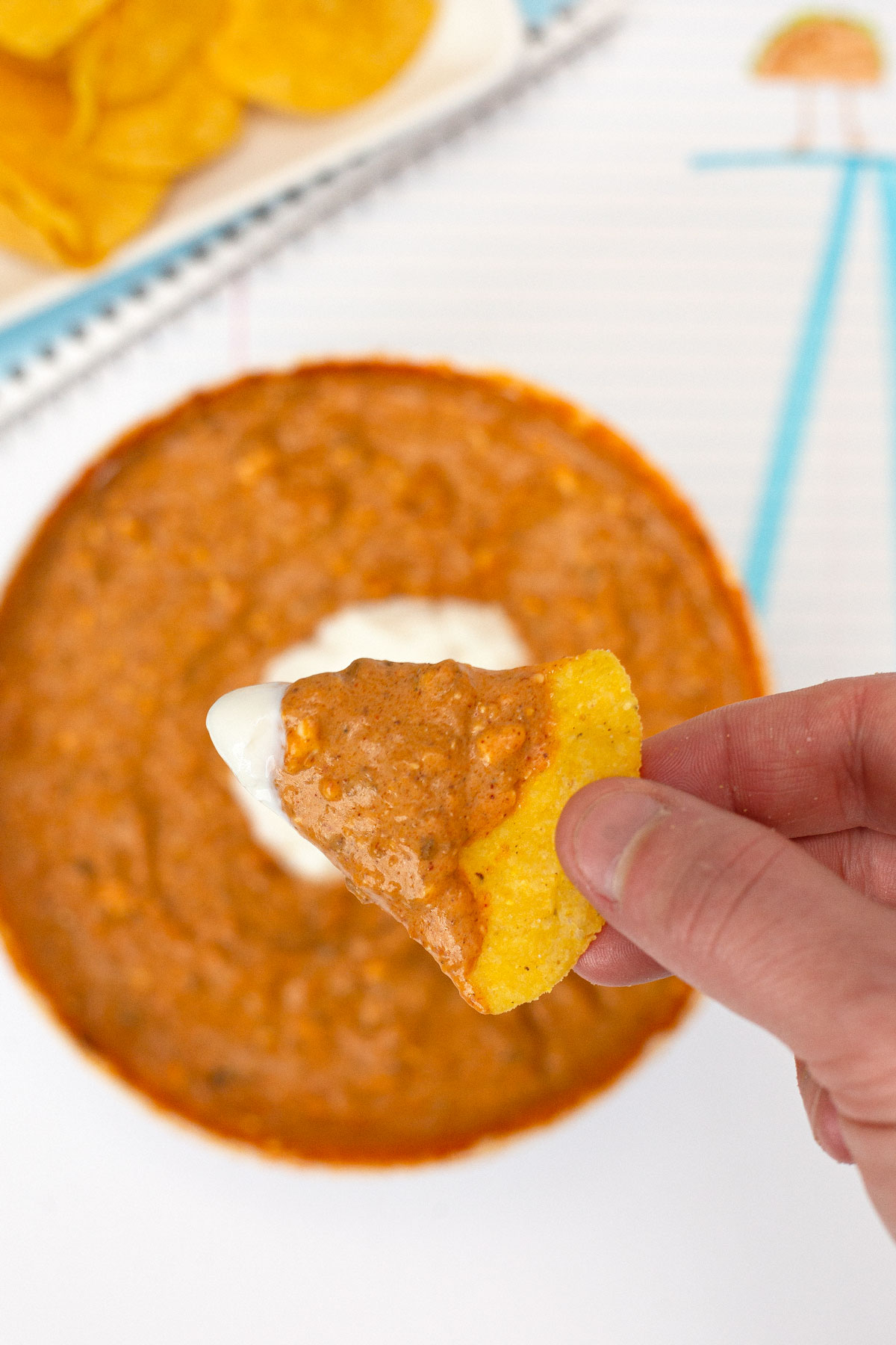 Microwave Cheesy Taco Dip scoop on tortilla chip