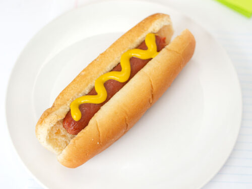 Microwave Hot Dog wiener on bun with mustard