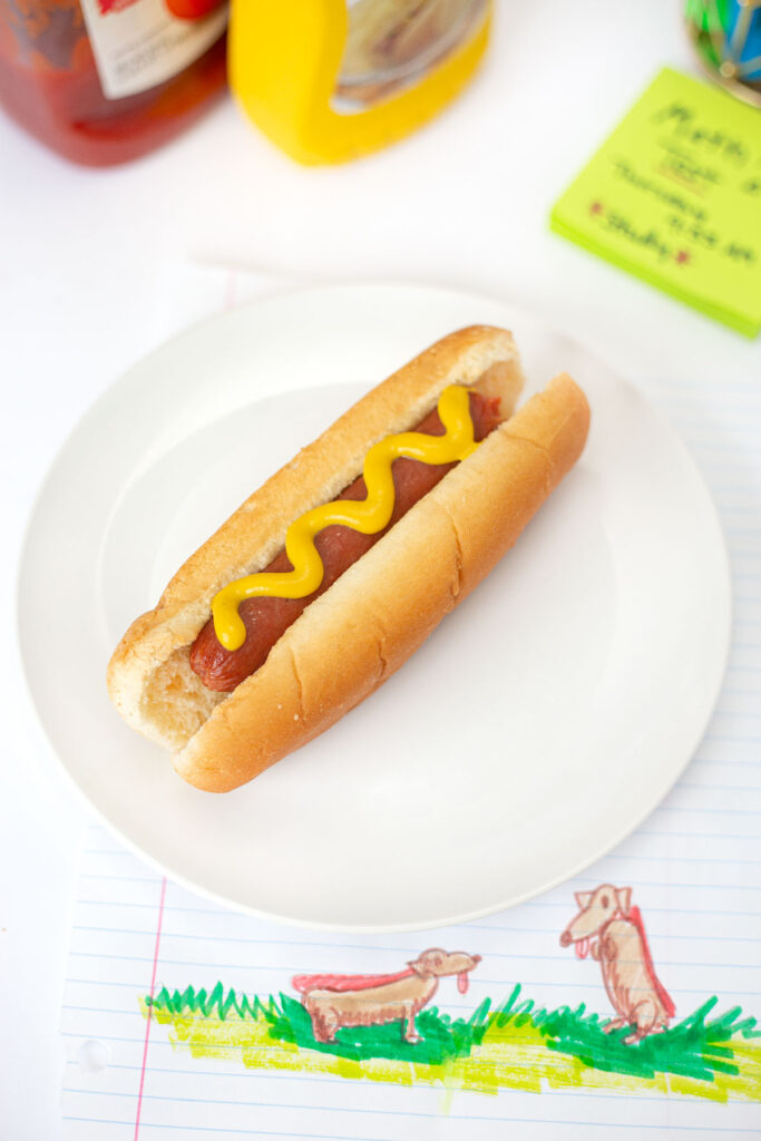 Microwave Hot Dog wiener on bun with mustard
